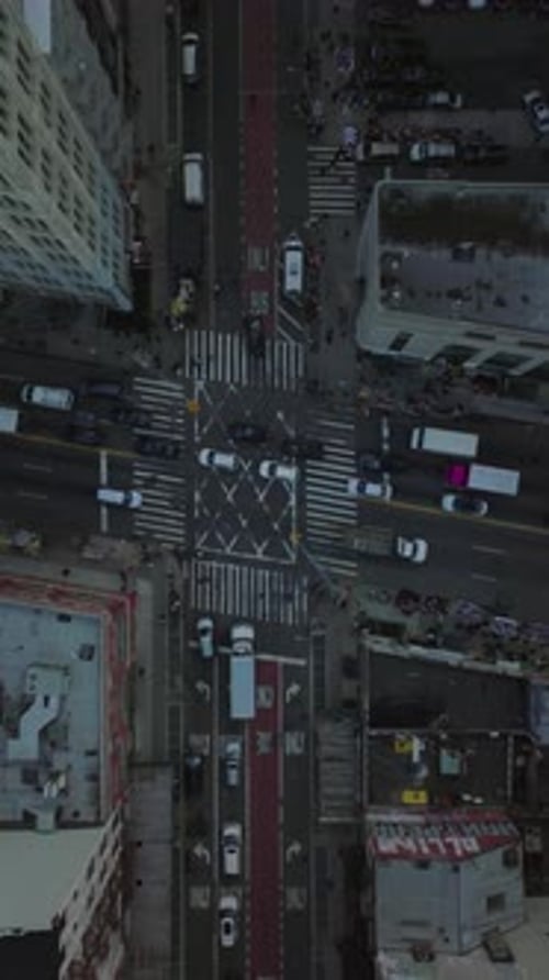 Cars Trucks and Pedestrians Navigating a Busy Manhattan Intersection in Slow Motion in New York City