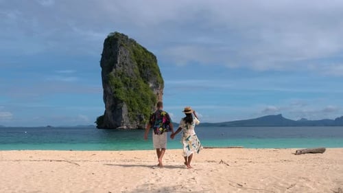 Couple Strolls Along the Stunning Beaches of Koh Poda Krabi Thailand on a Sunny Day