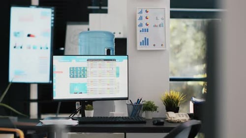 Modern Office Desk with Data on Computer Screen