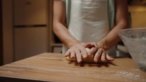 Adult Kneading Dough at Home on Wooden Table