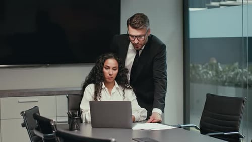 Collaborative Meeting in Modern Office with Professionals Reviewing Project
