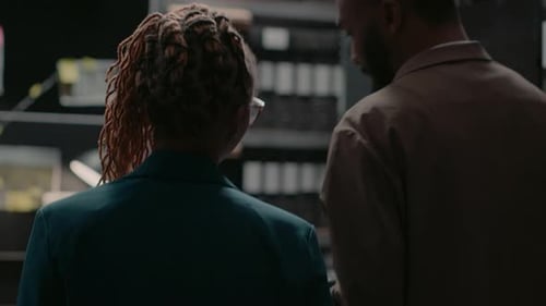 Two Investigators Reviewing Evidence in Office