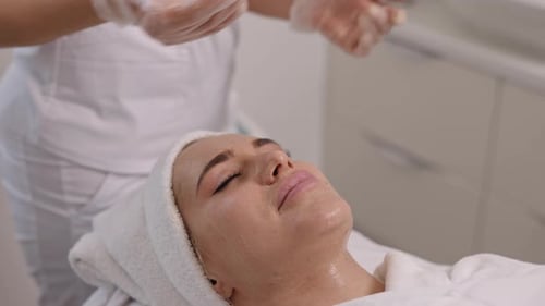Woman Receiving Facial Treatment in Hospital Environment