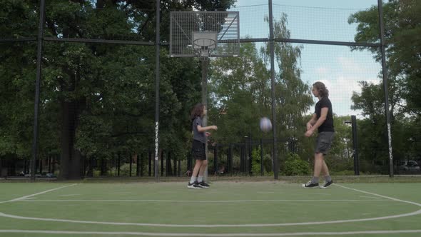 Two guys miss basketball shots, hitting the rim, but continue with ...