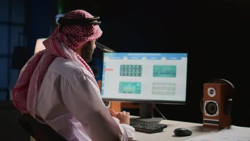 Man Analyzing Financial Data in Office at Night