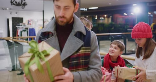 Family Christmas Shopping Trip with Gifts in Mall