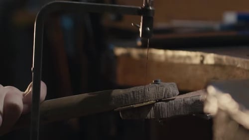 Woman Hand Jeweler Using Saw to Cut Metal