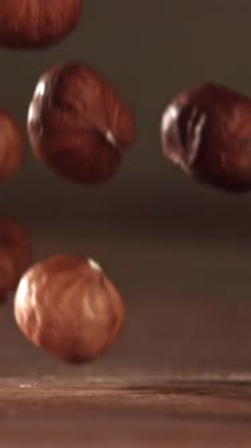 Hazelnuts Fall on a Wooden Table Filmed on a Highspeed Camera at 1000 Fps