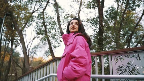 Attractive Young Woman Walking in Autumn Park Wearing Pink Jacket Going Down the Stairs Autumn Urban