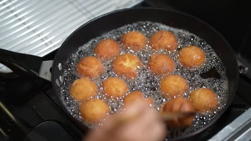 Woman making sata andagi