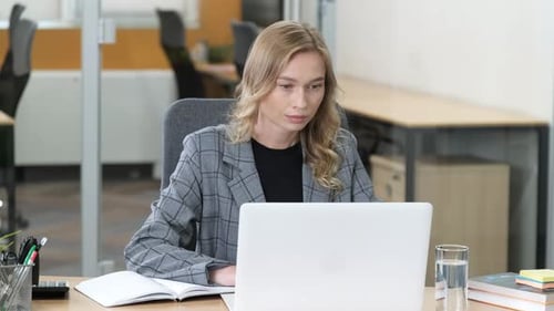 Businesswoman Working at Office Desk