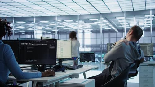 People Working at Computers in Modern Office