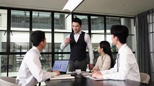 Enthusiastic Business Team Celebrating Success in Modern Office