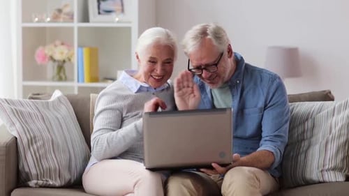 Senior Couple Video Chatting with Family on Laptop