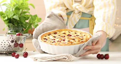Woman Presents Freshly Baked Cherry Pie at Home
