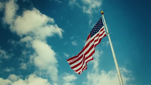 American Flag Waving Proudly on Blue Sky