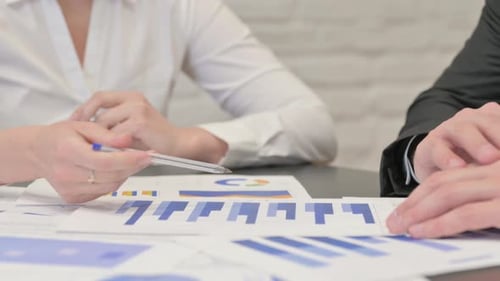 Close up of Business People Doing Paperwork in Office