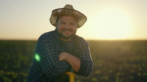 Joyful Farm Worker Leaning on Shovel After Hard Working in Field Portrait Smiling Middleaged Man in