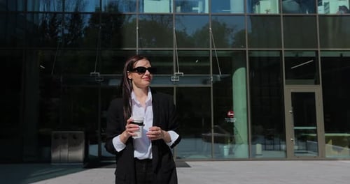 Businesswoman in Sunglasses Enjoying Coffee Walking Downtown Close Up Woman Holding Coffee Cup