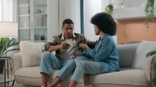 Couple Reacting to Positive Pregnancy Test at Home