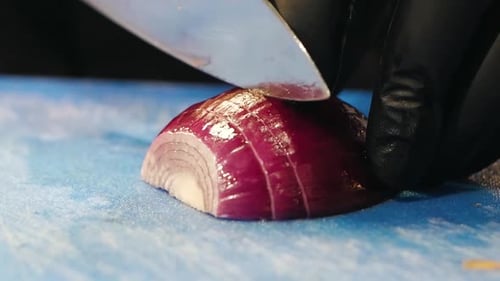 Chef Slicing a Red Onion with Precision
