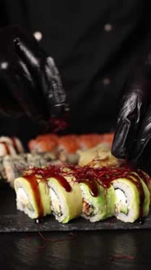 chef prepares rolls and sushi in the kitchen