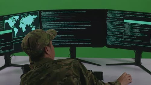 Back View Of Bored Asian Man Soldier Developer Write Code With Multiple Screens In Green Screen