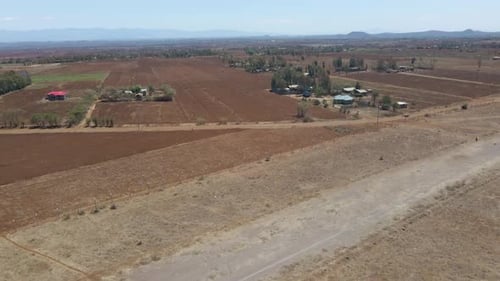 Jib up of farm houses in a beautiful rural landscape in Kenya