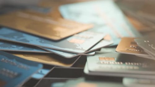 Camera movement along bank cards. Bank cards are scattered on the table.