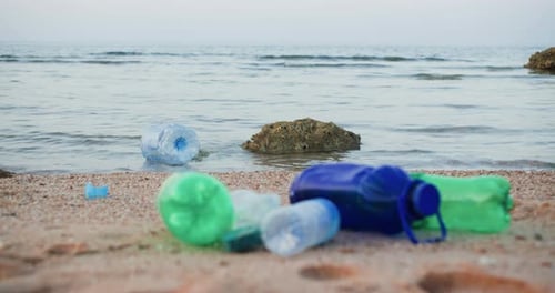 Plastic Bottles and Garbage on Sea Sandy Beach Environmental Pollution