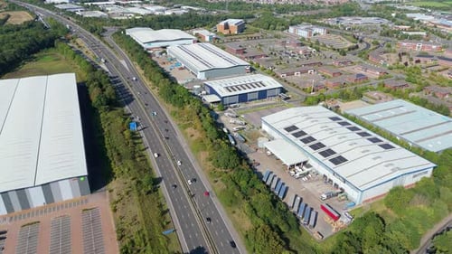 Aerial Drone Footage Capturing Large Warehouses and Factories Beside Industrial Zones