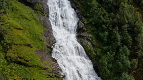 Beautiful Norwegian Waterfall Among Green Forest