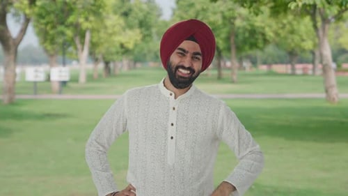 Sikh Indian man laughing on someone in park