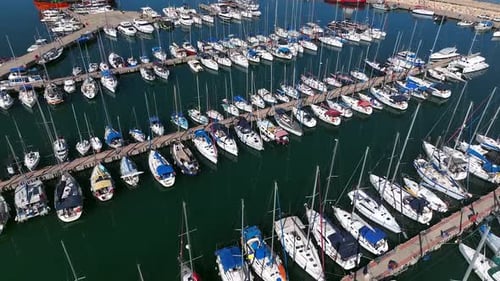 Boats and small sailing Yachts docked in a beautiful marina, Top down view