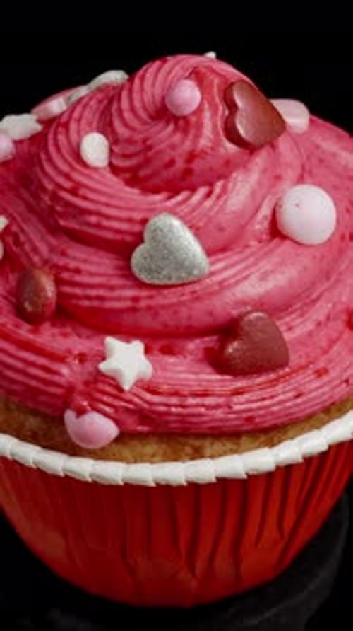 Delicious Cupcake with Pink Frosting and Sweet Toppings