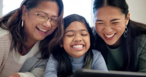 Laughing Family Using Tablet Device Together Inside