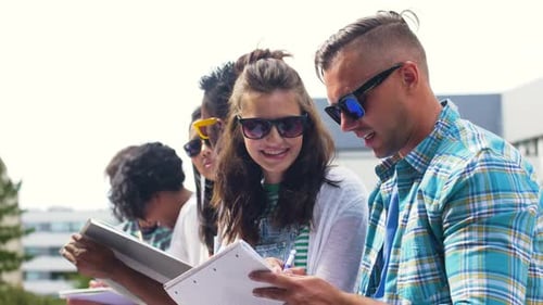 Diverse Group of Students Writing Together on Campus