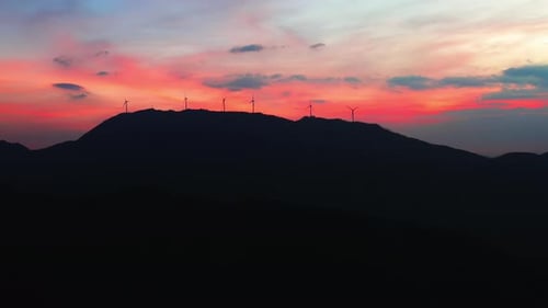 Wind Turbines on Mountain at Colorful Sunset