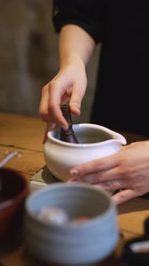 Matcha Process of Making Green Tea in a Bowl on Wooden Table Background
