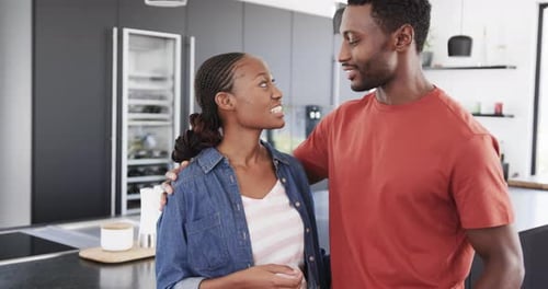 Loving Couple Embracing in Modern Kitchen
