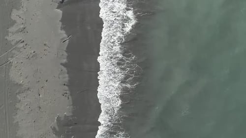 Top View of a Sandy Beach Sea Waves Crashing on the Shore Sea Foam