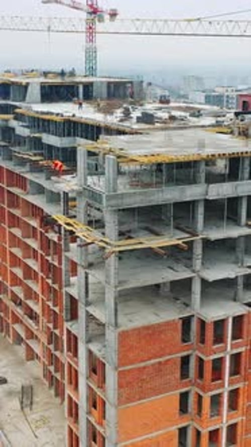 Construction of a residential apartment complex. Aerial view. Vertical video