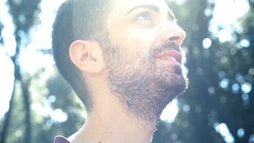 Man Smiling and Looking Upward on a Sunny Day