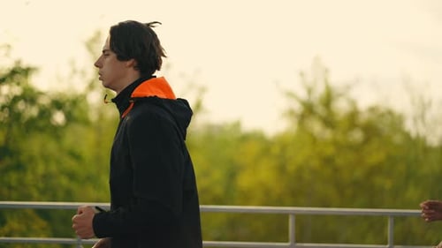 Young Adults Running Together Outside During the Day