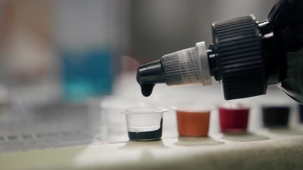 The process of pouring tattoo ink into a container, tattoo studio ...