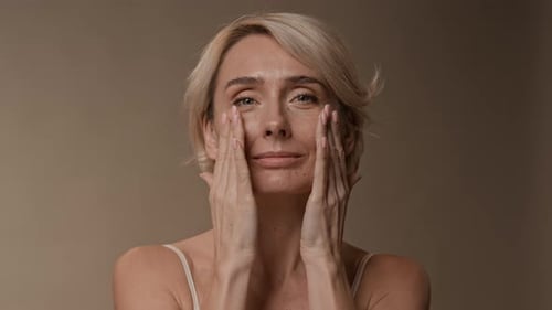 Woman Applying Facial Cream for Skincare Routine