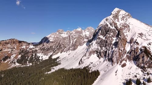 Aerial View of a Majestic Snow-Covered Mountain Range