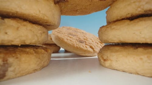 The camera passes through cookies with chocolate pieces. Dolly slider close-up.