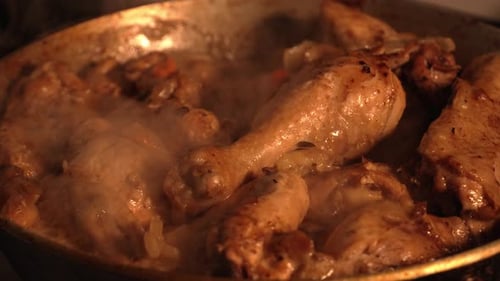 Golden-Brown Chicken Simmering in a Pan