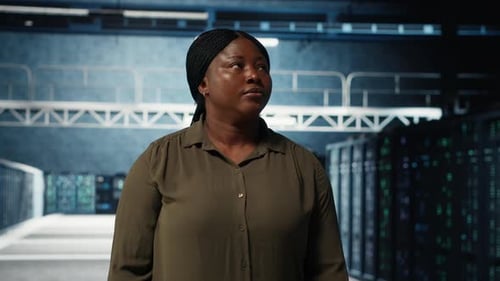 Portrait of Jolly Data Center Engineer Overseeing IT Equipment